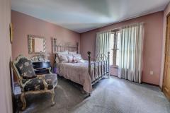 The third bedroom has custom drapes and carpet.