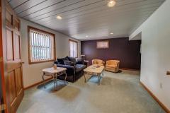 The sitting room is off the bedroom in lower level, it has custom window treatments and carpet and has double doors.