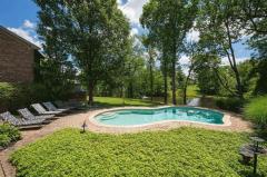 The down stairs walks out to the pave patio and pool that is great for entertaining. There are 6 chase lounges around pool and it is beautifully landscaped.