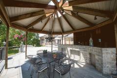The gazebo is very large with glass at top to let the light in and lots of light in the gazebo and a lot of lights around the patio. There is stone bar with granite top and lots of storage under bar. There is wrought iron around the patio