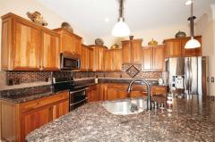 Staggered Cabinetry, gleaming Granite and Stainless appliances will delight the cook! Huge Counter/Bar and spectacular backsplash adds pinache.