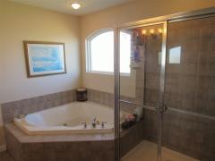 Master bath features tiled jetted tub, separate shower & double vanity.