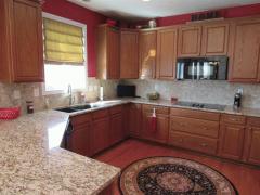 Kitchen boasts granite, backsplash, and hardwood floors.