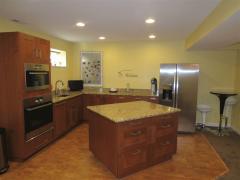 Basement kitchen complete with full sized refrigerator, dishwasher, microwave & convection oven. Beautiful granite counters and cork floor.