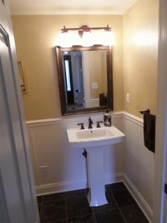 Half bath, high end tile, fixtures, and wainscoting.