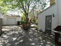 Pavers arranged to create a patio space to sit and enjoy the peaceful private back yard. Surrounded by privacy fencing and covered with shady trees!
