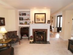 The living room features a gas fireplace, built in shelving, and adjoins to the granite topped bar between the kitchen. Excellent for entertaining guests!