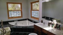 Custom ceramic tile corner whirlpool tub, double vanities, separate shower, dressing area, stained glass windows. Wow!