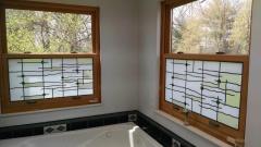 Double sinks, vanity and lots of open space, ceramic tile floors and tub.