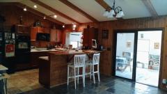 Breakfast Bay with counterbar, walks out to ceramic tile floored solarium and deck.