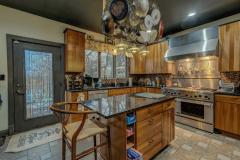 Gourmet Kitchen is a chefs dream, featuring Jenn Aire 6 burner stove top with grill. Island/work area with Granite Counter Tops. Oversize Stainless Steel Fridge Freezer.