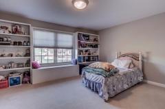 Any girl or boy would love this huge bedroom. Check out the built in shelves and built in window seat!