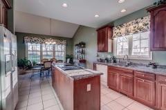 Your dream kitchen offers one year old granite counter tops new garbage disposal. Jenn air smooth surface top range.Neutral tile flooring, beautiful cabinets, pantry, pull out spice rack with hidden space behind the rack. Custom made window treatments. Re