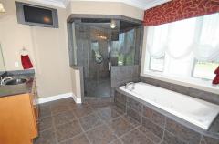 Designer bath boasts walk-in shower with dual shower head