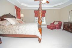 Master offers tray ceiling, crown molding and window seat