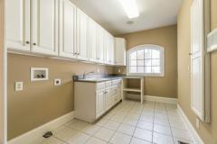 Would you enjoy doing laundry here? Plenty of cabinet storage for cleaning supplies and folding clothes, awesome pocket door, and cute window!