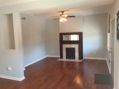 Beautiful hardwood floors, marble fire place (non-operational), with window treatments, 2 ceiling fans and a walkout to a nice front porch.