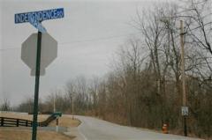 View of property shows road frontage to the left of Independence Rd & Maher Rd intersection.