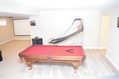 Space for a pool table and more! A 1/2 bath and plenty of unfinished storage area finish out this lower level!