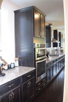 Extra counter space to the side of the double ovens serve as the butler's pantry while a walk in pantry is just across from this space!