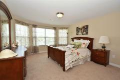 Charming! Wonderful Bay Window and neutral Decor makes this Bedroom so appealing!