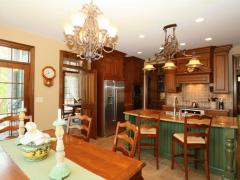 Eating area looks into kitchen and dining room.
