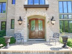 Beautiful wood doors greet you as you enter this custom built beauty by Tim Burks.