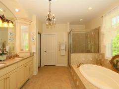 Master bath view toward oversized walk in closet with extensive built ins.