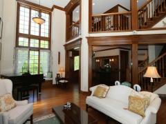 Another view from the living room shows the second floor overlook from the library.