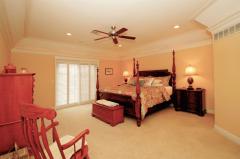 Indirect Lighting and a coffered ceiling highlight the first floor Master Bedroom.