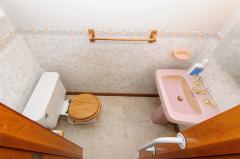 Partial bath in MBR with new vinyl wood plank floor.