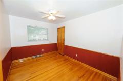 BR3 with ceiling fan & hardwood floor.