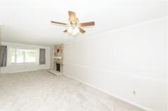 Brand new carpet and vinyl wood plank floor at entry. Wood burning fireplace, crown molding and chair rail dress up the room!