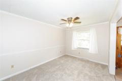 Sunlit room with ceiling fan and brand new carpet!