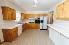 Brand new vinyl wood plank floor and all appliances stay! Walk out to huge maintenance free deck and access yard and concrete patio downstairs.