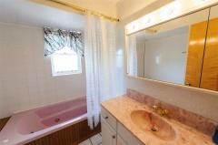 1st floor full bath with ceramic tile, jetted tub and shower, & XL vanity with drawers.
