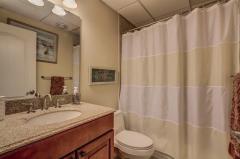 Lower Level full bath, granite countertop, ceramic tile, and tub/shower combo