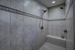 Custom ceramic tile walk-in master shower with dual shower heads