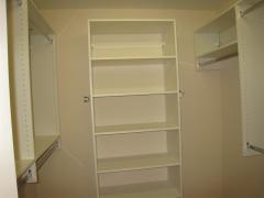 Master walk-in closet features dual rods, shelving, dry cleaning rod, tie rack and belt holder!