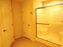 Master bath shower with overhead transom, linen closet & commode room!