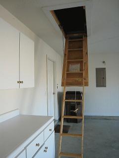 Garage cabinetry & pull-down stairs provide access to storage attic!