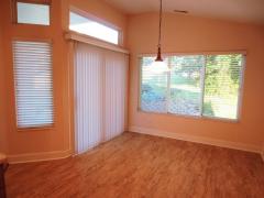 Dining area overlooks private tree-lined yard and opens to a covered patio with expanded area great for entertaining guests!