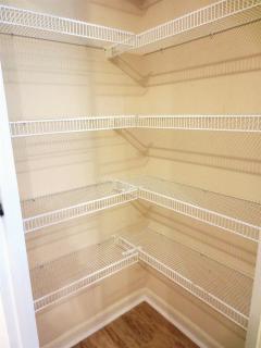 The large kitchen pantry offers plenty of storage space for small appliances, can goods, etc.