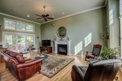 Great room has crown molding and cozy fireplace
