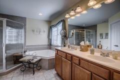 Designer bath has jetted tub, step-in shower and dual vanity