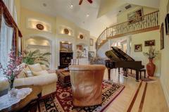 Custom hardwood floors/soaring ceiling/built-in shelving, expansive views of the covered deck/your private view of the woods!