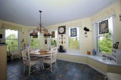 You'll enjoy the warmth of this Breakfast Room. Located in a turret, 5 windows overlook the acreage.