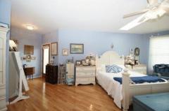 Access to the screened porch plus a skylight makes the master bedroom bright and cheerful all day long.