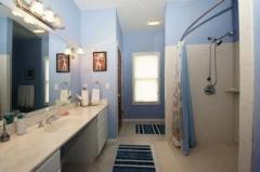 Totally handicap accessible, this full bath has a tile shower that you could roll into. The commode area is large enough for a wheelchair.