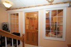 The Finished lower level has tiled floors throughout. This room has a glass door and windows and was constructed for the owner to display her doll collection. It is perfect for any type of collectibles or for an exercise area.